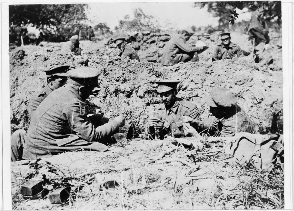 A group of soldiers in the trenches at Gallipoli, playing cards and relaxing